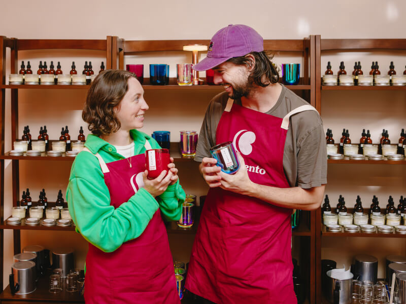 Couple showing off handmade candles